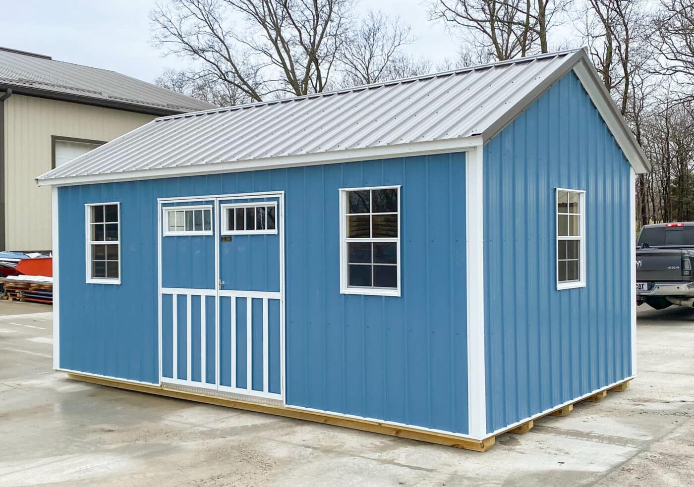 a blue cottage shed made by Premier Barns in Missouri