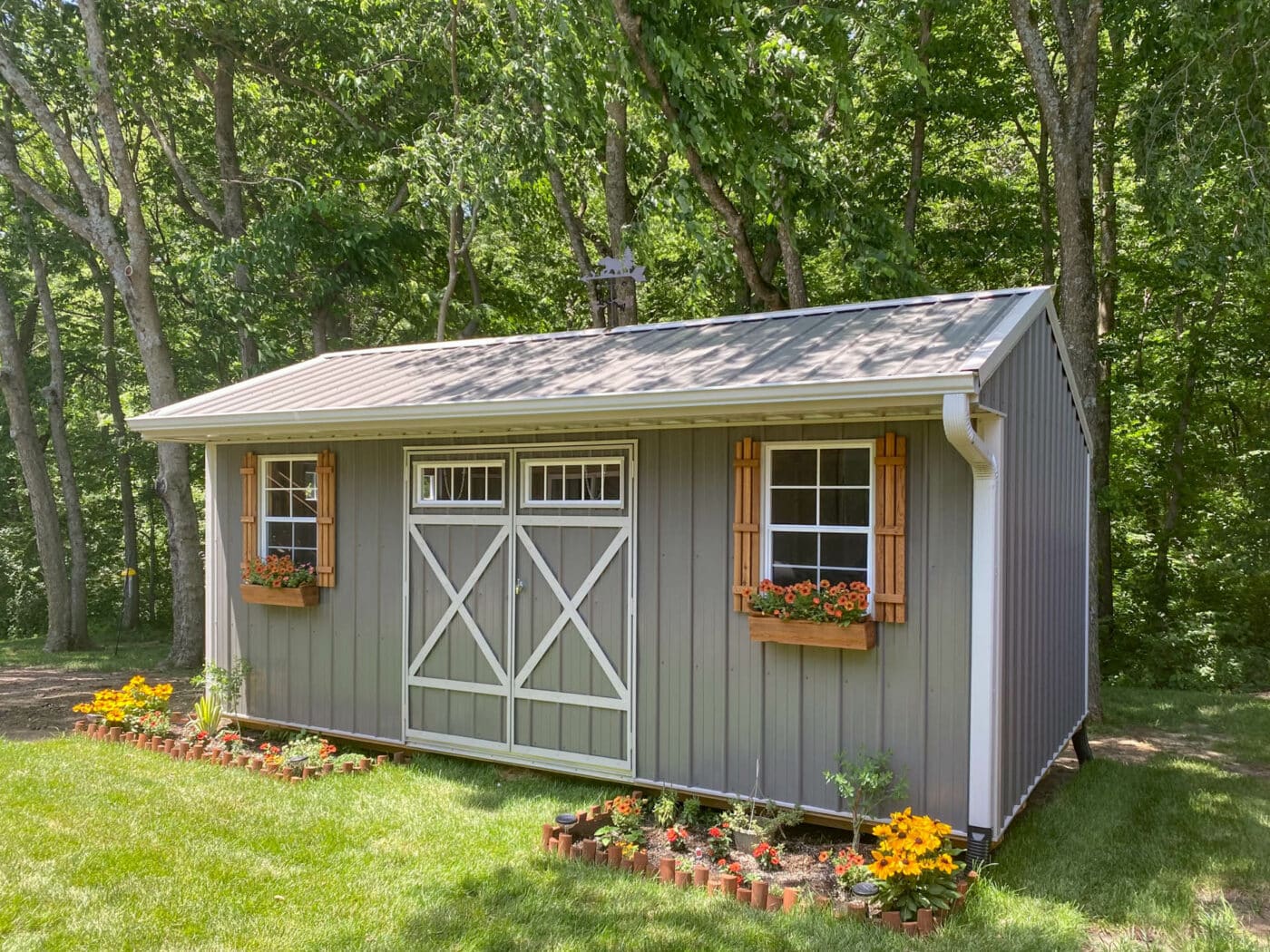 a garden shed built by Premier Barns in Missouri with shutters, weather vane, and shutters