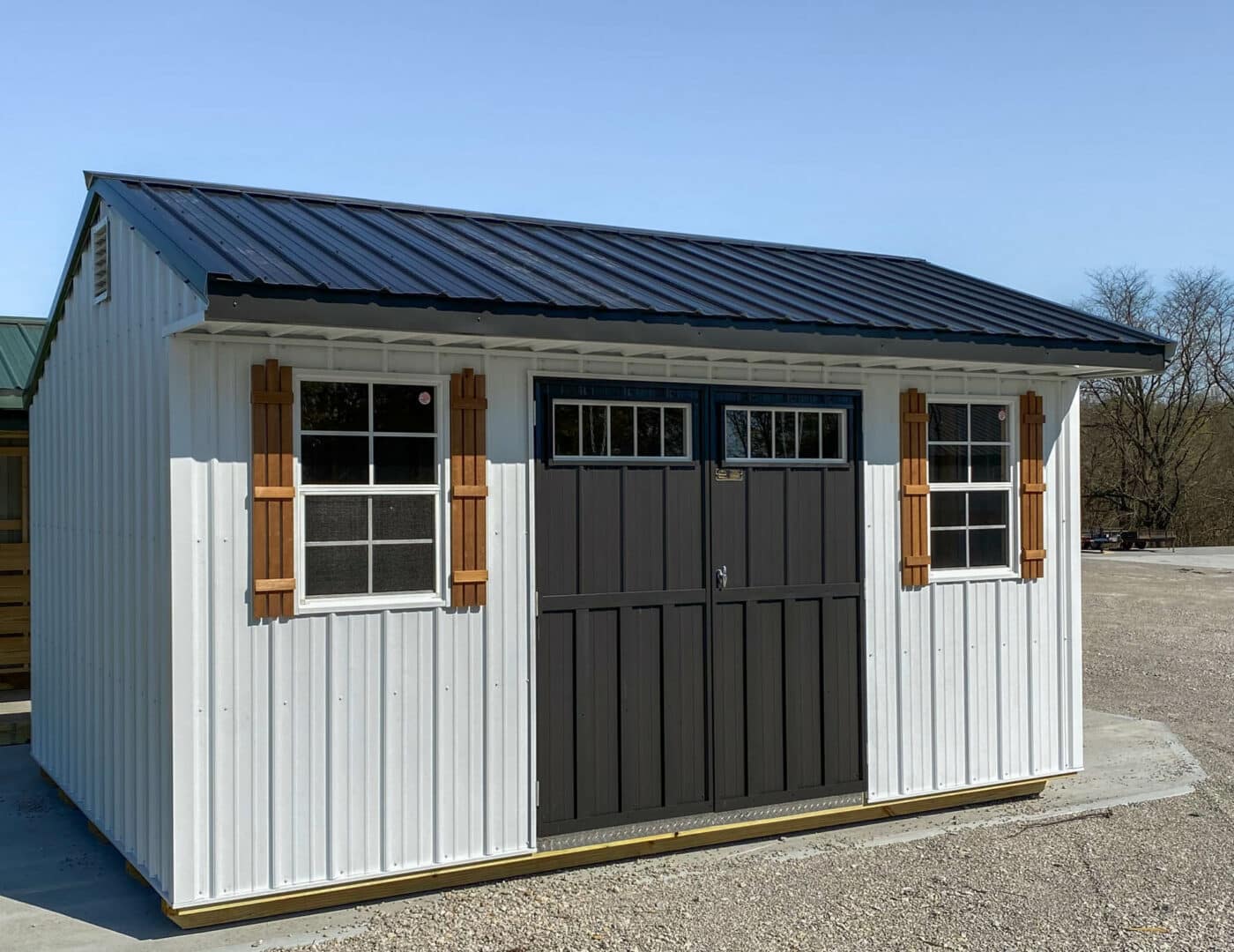 white garden shed with black doors and shutters by Premier Barns in Missouri