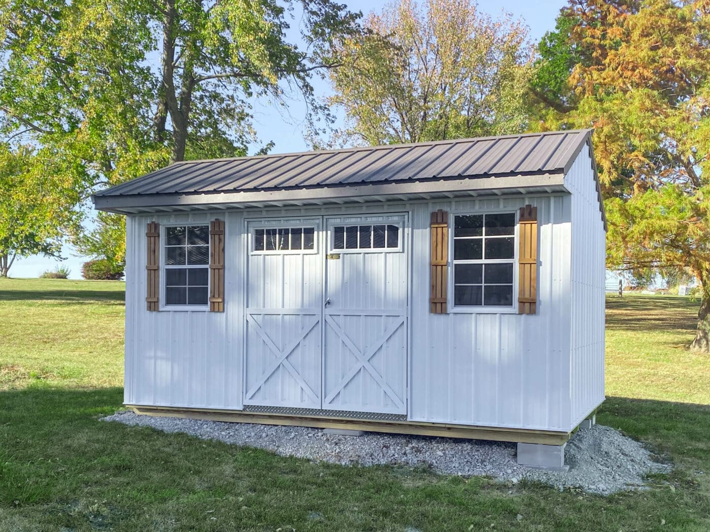 white garden shed by Premier Barns in Missouri with shutters