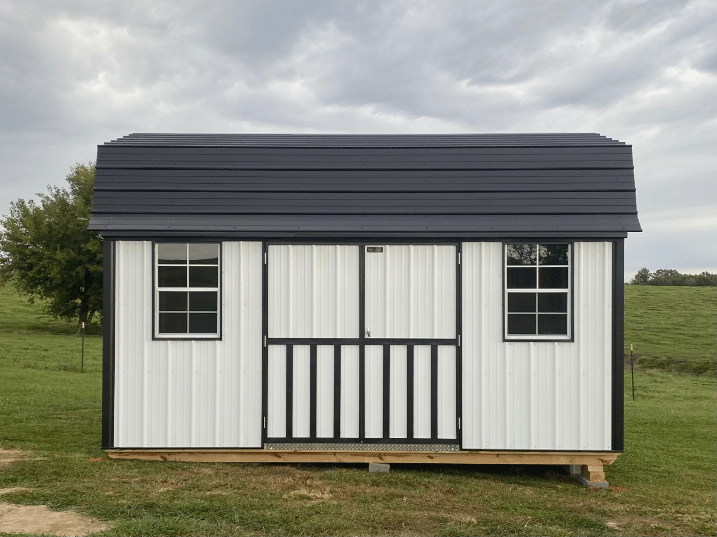 black and white highwall lofted barn with windows in missouri