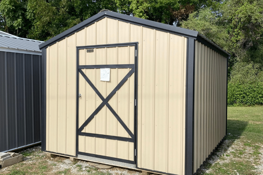 tan and black trimmed metal shed available to rent to own