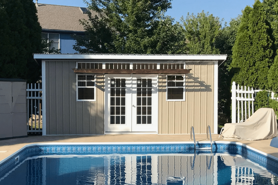 tan and white 10x12 shed by pool