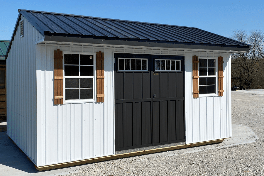 white and black garden 10x12 sheds with double black doors with transom windows and two windows with brown shutters